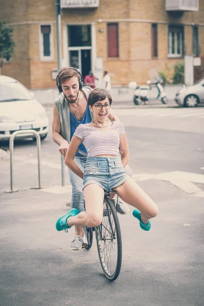 Couple d'amis jeune homme et femme à vélo — Photo