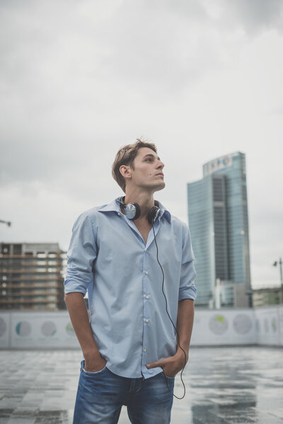 young model hansome blonde man with headphones