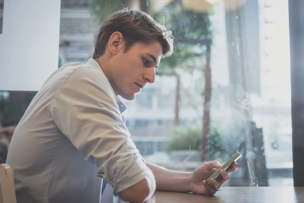 Ung modell hansome blond man använder smartphone — Stockfoto