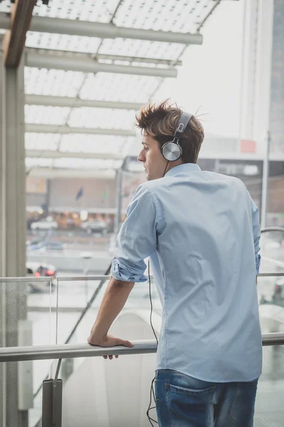 Joven modelo hansome hombre rubio con auriculares — Foto de Stock