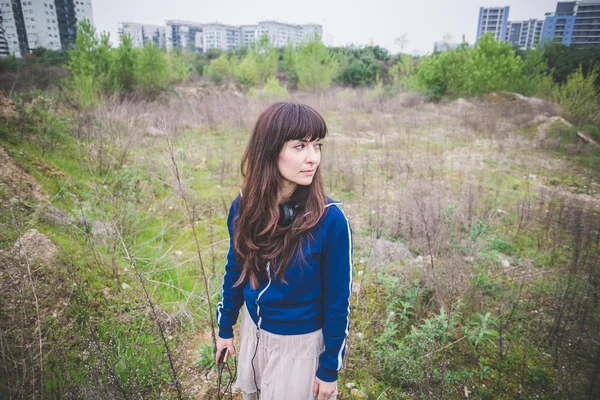 Beautiful woman in a desolate landscape — Stock Photo, Image