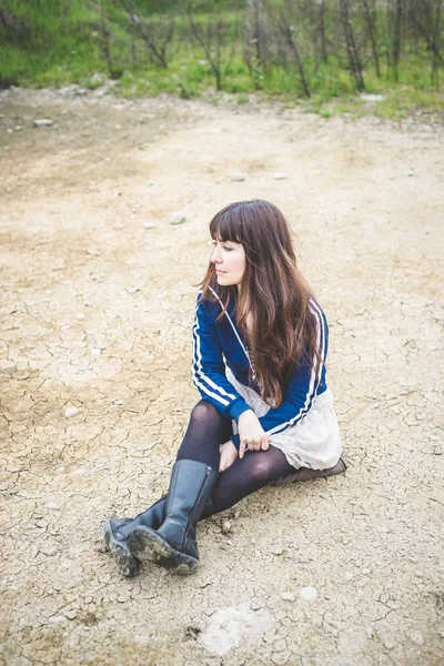 Beautiful woman in a desolate landscape — Stock Photo, Image