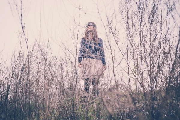 Beautiful woman in a desolate landscape — Stock Photo, Image