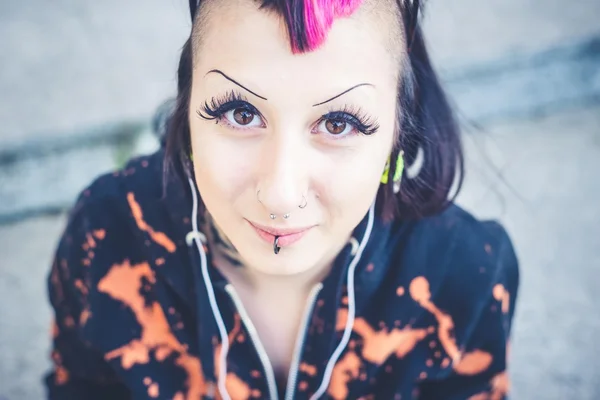 Young beautiful punk dark girl listening music — Stock Photo, Image