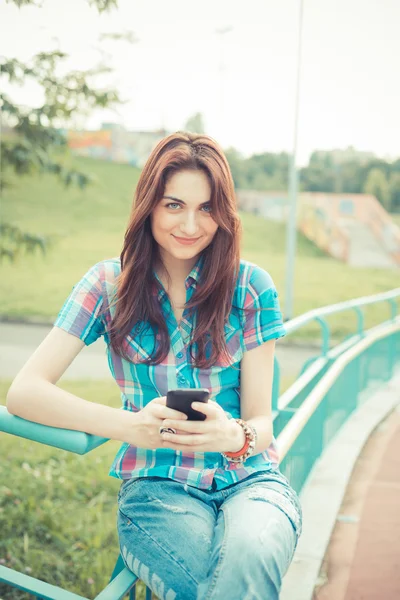 Beautiful young hipster woman using smartphone — Stock Photo, Image