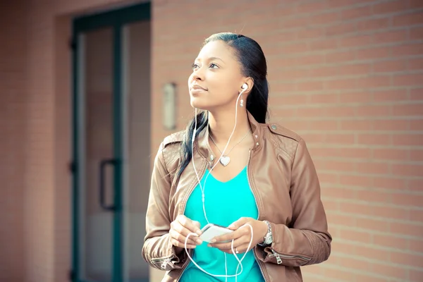 Güzel Afrikalı genç kadın müzik kulaklık dinleme — Stok fotoğraf