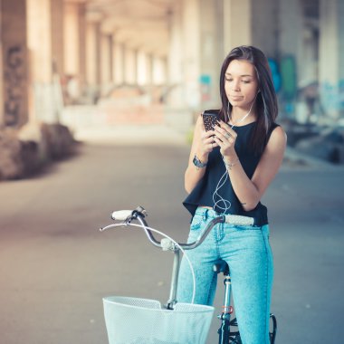 Bisiklet ve zeki kullanan genç güzel esmer düz saçlı kadın