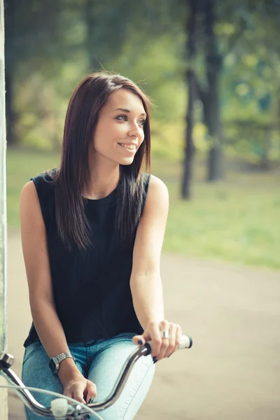 Young beautiful brunette straight hair woman using bike — Stock Photo, Image