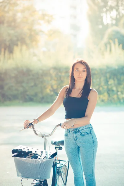 Young beautiful brunette straight hair woman using bike — Stock Photo, Image
