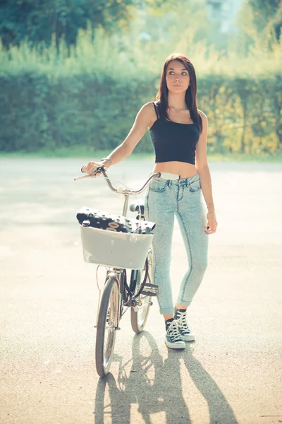 Young beautiful brunette straight hair woman using bike — Stock Photo, Image