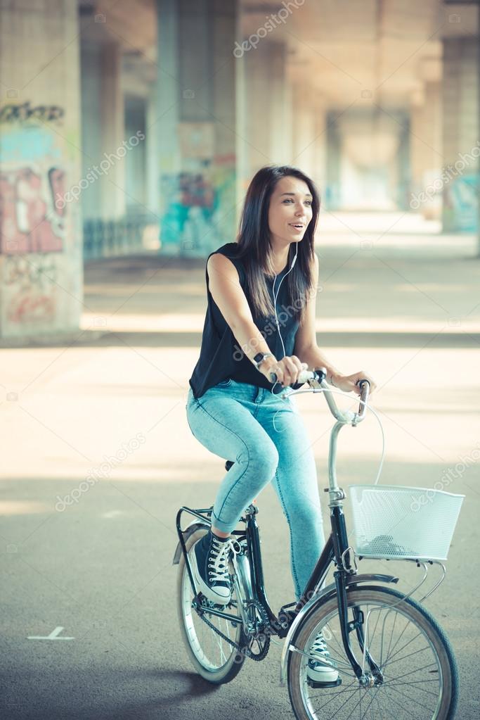 young beautiful brunette straight hair woman using bike and smar