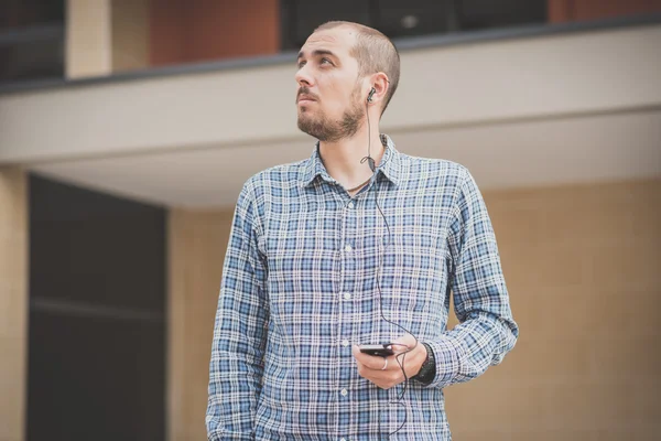 Handsome hipster casual multitasking modern man listening music — Stock Photo, Image