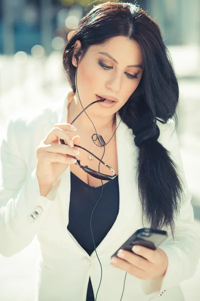 Krásné dlouhé černé vlasy elegantní obchodní žena pomocí smartphon — Stock fotografie