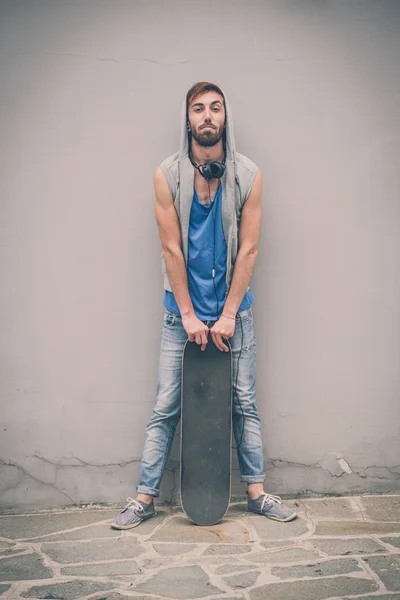 Young hipster gay man with skate — Stock Photo, Image