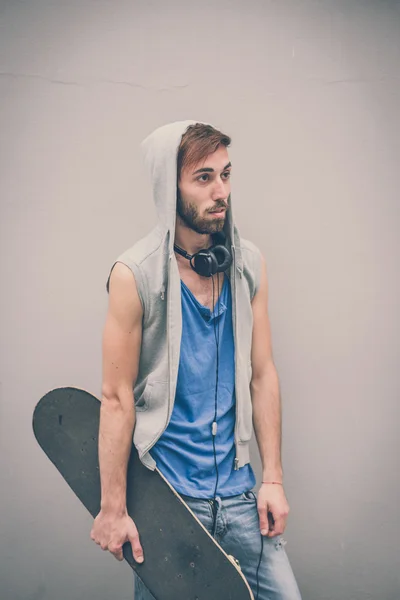 Young hipster gay man with skate — Stock Photo, Image