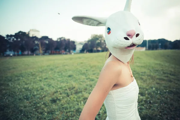 Rabbit mask absurd beautiful young woman with white dress — Stock Photo, Image