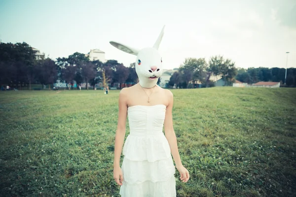 Rabbit mask absurd beautiful young woman with white dress — Stock Photo, Image