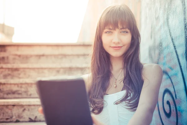 Beautiful young woman with white dress using tablet — Stock Photo, Image