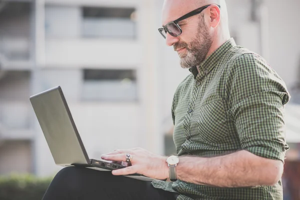 Bonito homem de meia idade usando notebook — Fotografia de Stock