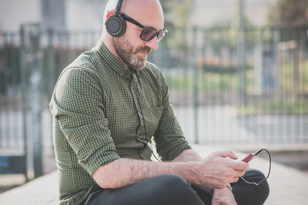 Knappe middelbare leeftijd man luisteren muziek — Stockfoto