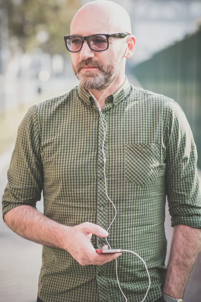 Handsome middle aged man listening to music — Stock Photo, Image