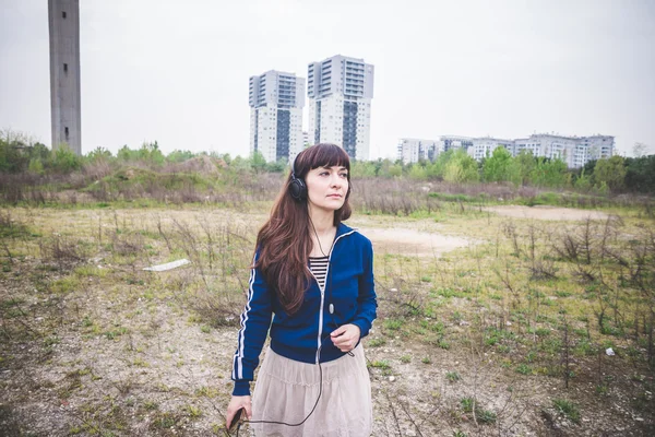 Beautiful woman in a desolate landscape — Stock Photo, Image