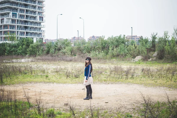 Beautiful woman in a desolate landscape — Stock Photo, Image