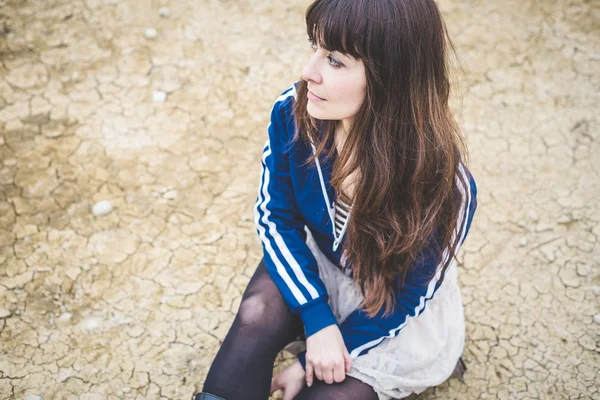 Beautiful woman in a desolate landscape — Stock Photo, Image