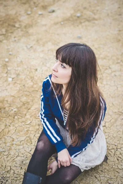 Beautiful woman in a desolate landscape — Stock Photo, Image