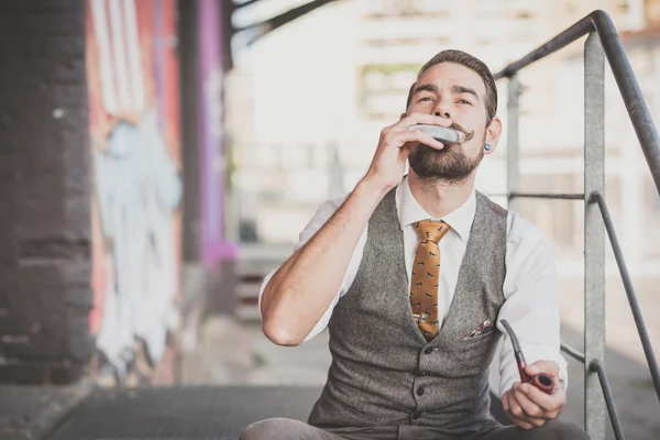 Handsome big moustache hipster man smoking pipe — Stock Photo, Image