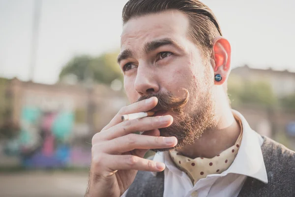 Handsome big moustache hipster man smoking cigarette — Stock Photo, Image