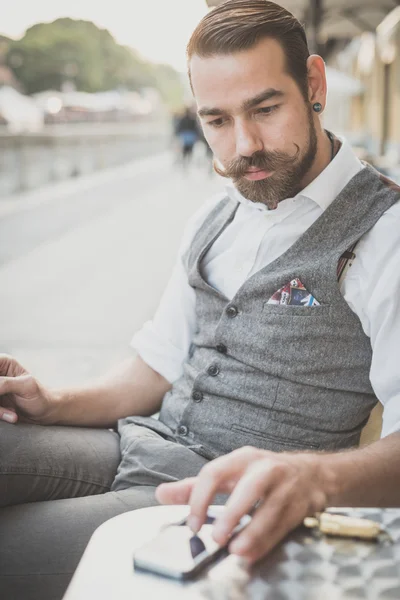 Handsome big moustache hipster man using smart phone — Stock Photo, Image