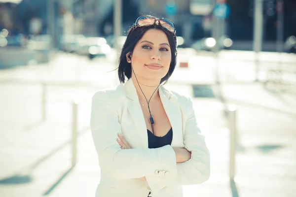 Elegant business woman with earphones — Stock Photo, Image