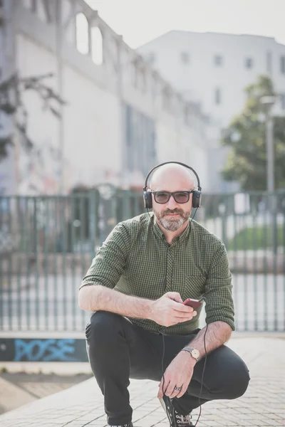 Handsome middle aged man listening music — Stock Photo, Image