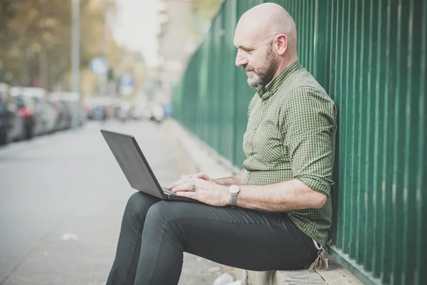 Handsome middle aged man using notebook — Stock Photo, Image