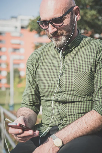 Handsome middle aged man listening to music — Stock Photo, Image