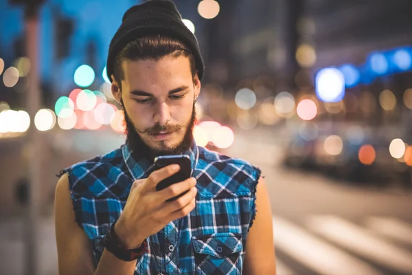 Hipster man använder smartphone och lyssnar musik — Stockfoto