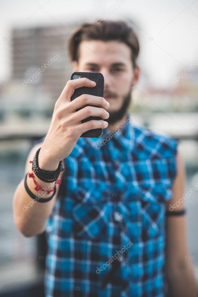 Hipster man making selfie by mobile phone