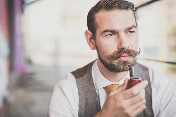 Man with big moustache smoking pipe — Stock Photo, Image