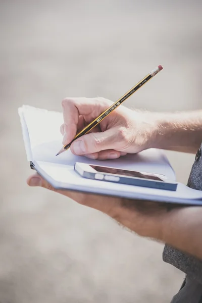 Hands writing on diary — Stock Photo, Image