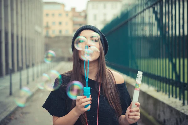 Beautiful girl blowing bubbles — Stock Photo, Image