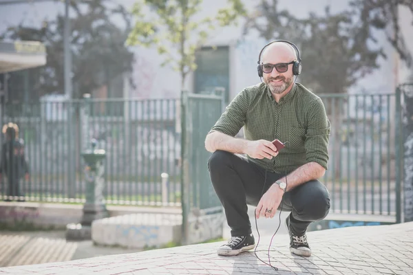 Middle aged man listening to music — Stock Photo, Image