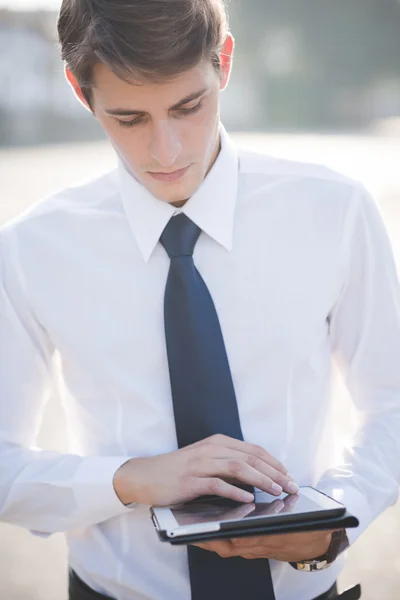 Blonde man using tablet device — Stock Photo, Image