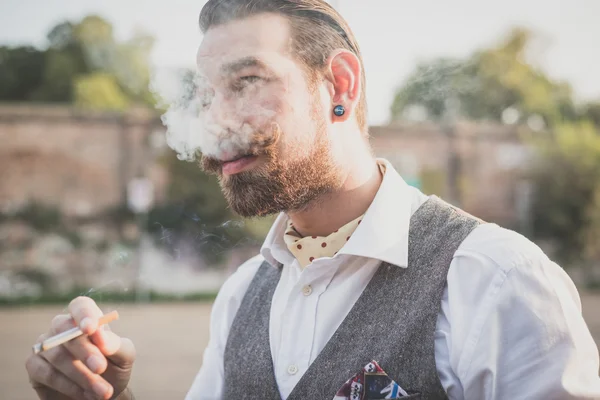 Man with big moustache smoking cigarette — Stock Photo, Image