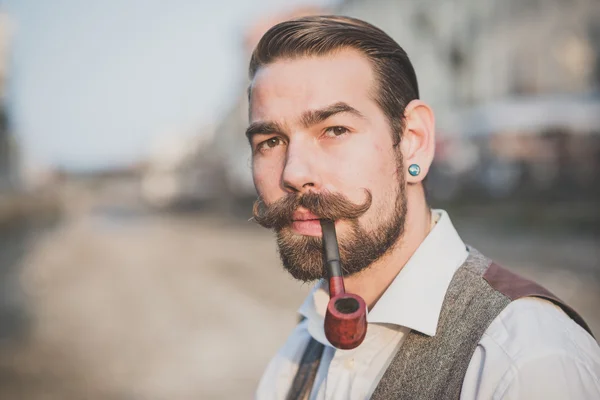 Man with big moustache smoking pipe — Stock Photo, Image