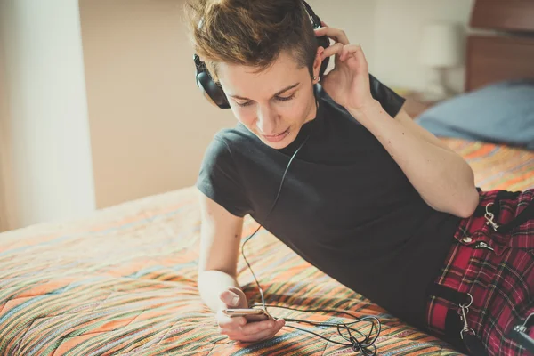 Young lesbian stylish hair style woman listening to music — Stock Photo, Image