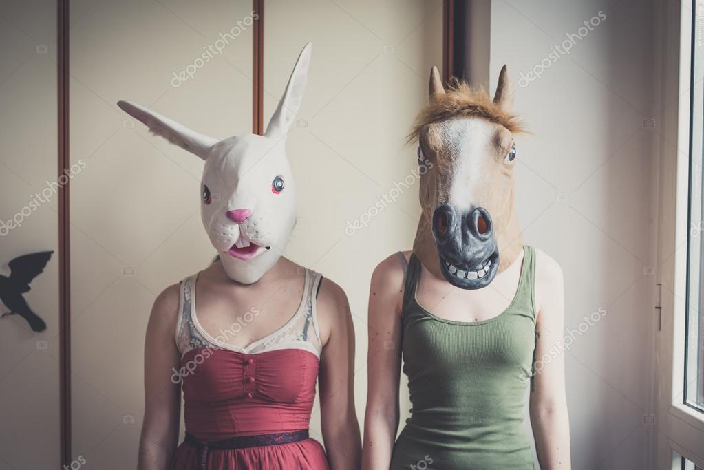 Lesbian couple in rabbit and horse masks — Stock Photo © peus #62237709
