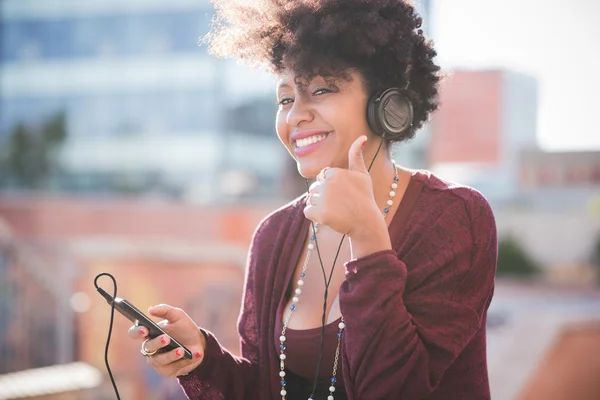 Woman listening music with headphones Stock Photo by ©peus 123292608