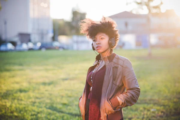 Schöne afrikanische Frau hört Musik — Stockfoto