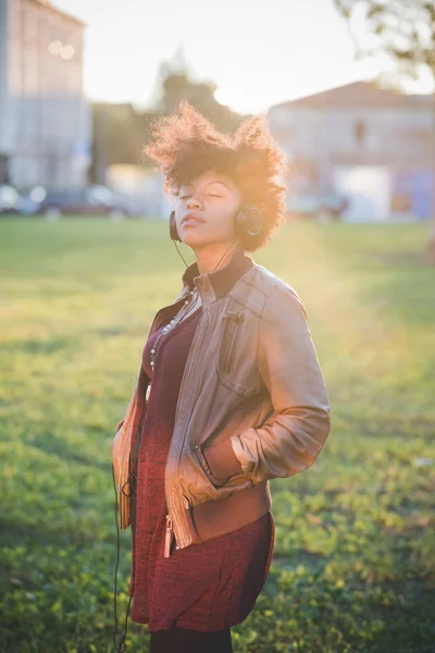 Hermosa mujer africana escuchando música — Foto de Stock